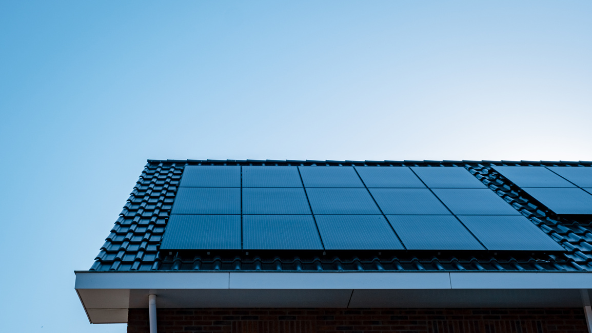 Newly build houses with solar panels attached on roof against a sunny sky Close up of solar pannel